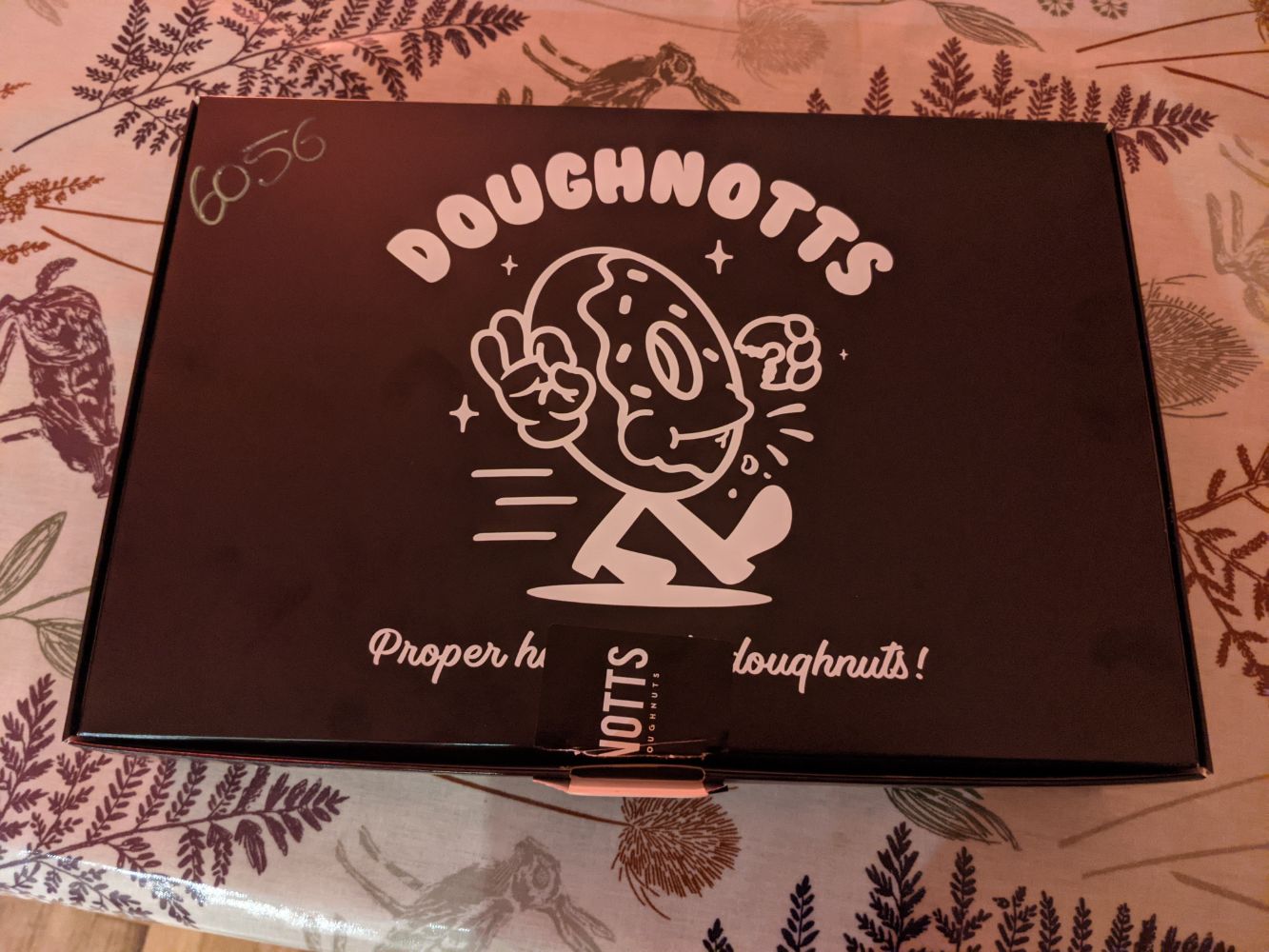 The Doughnotts packaging, with an anthropomorphised doughnut walking and smiling