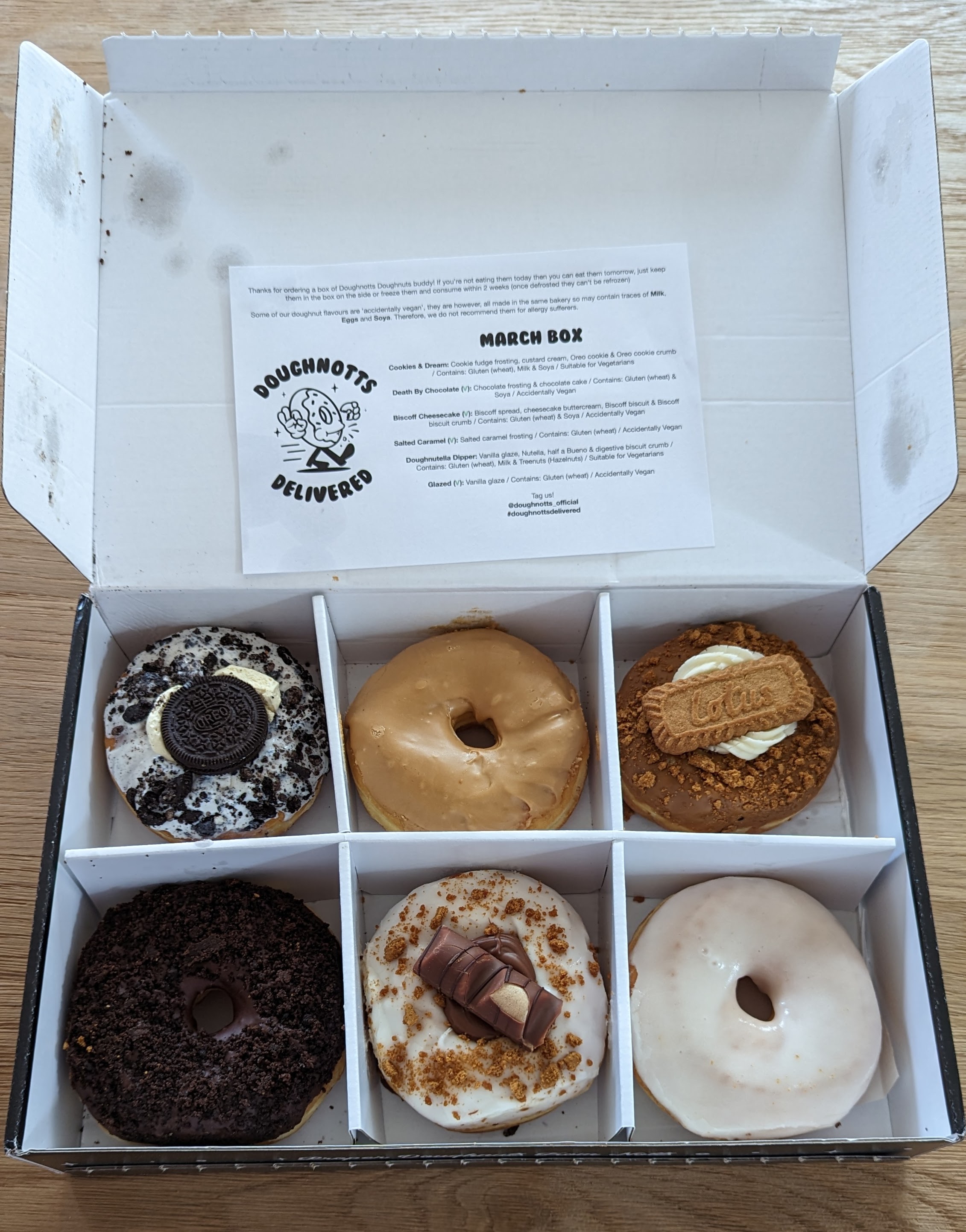 A box of six DoughNotts doughnuts - Cookies and Cream, Salted Caramel, Biscoff Cheesecake, Death By Chocolate, Doughnutella Dipper, Glazed