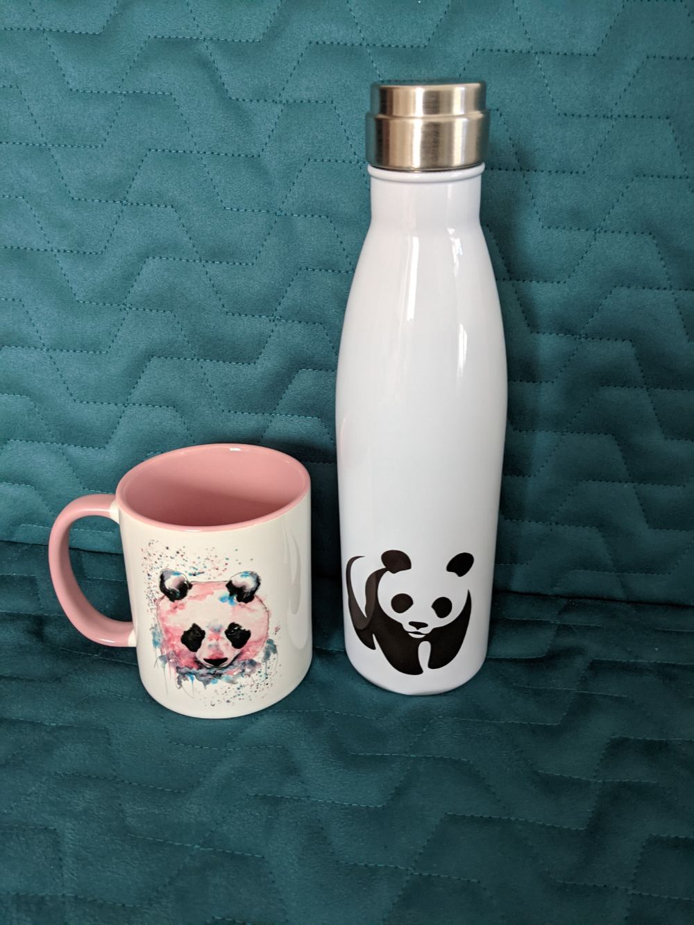 A painted pink-hued panda mug by Elizabeth Grant, and a vaccum bottle with the World Wildlife Fund panda logo on it