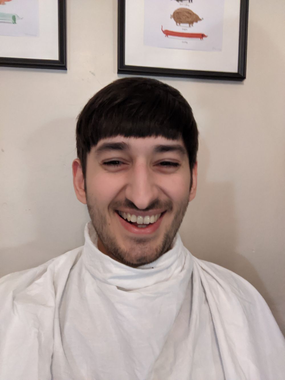 Selfie of Jamie after the haircut, with a trimmed beard and moustache, and considerably less hair, looking much happier