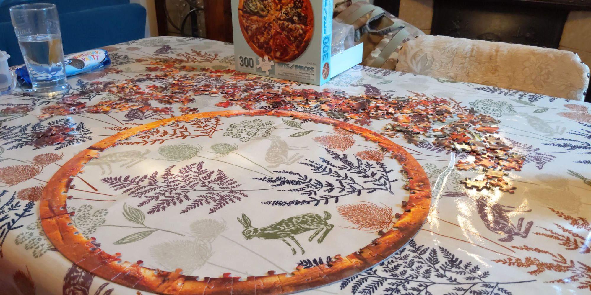 The start of a 300 piece pizza puzzle, with just the outsides set up