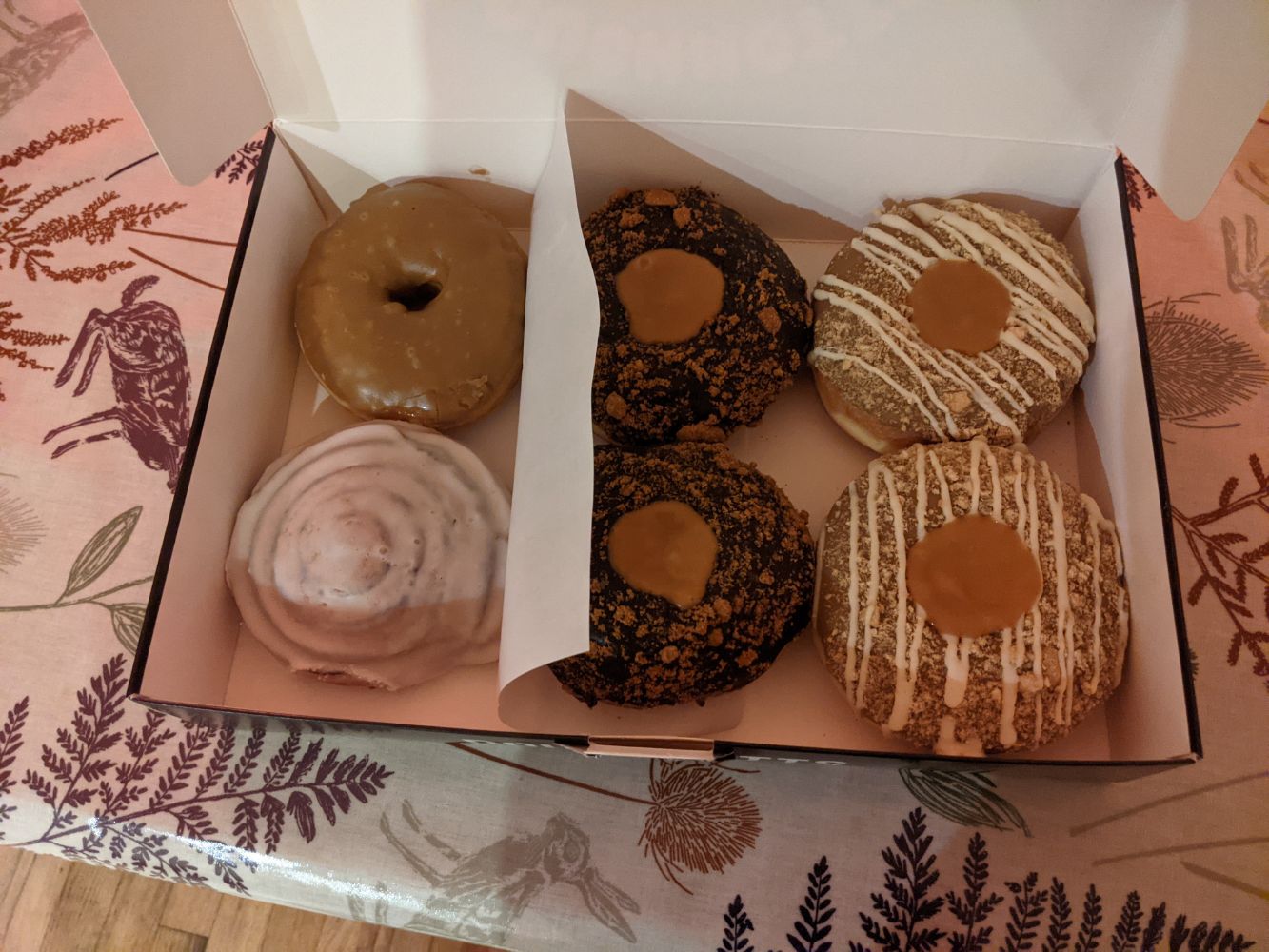 A box of very large Doughnotts doughnuts - Salted Caramel, Cinnamon Scroll, two Weekend Billionaires and two Caramel Tarts