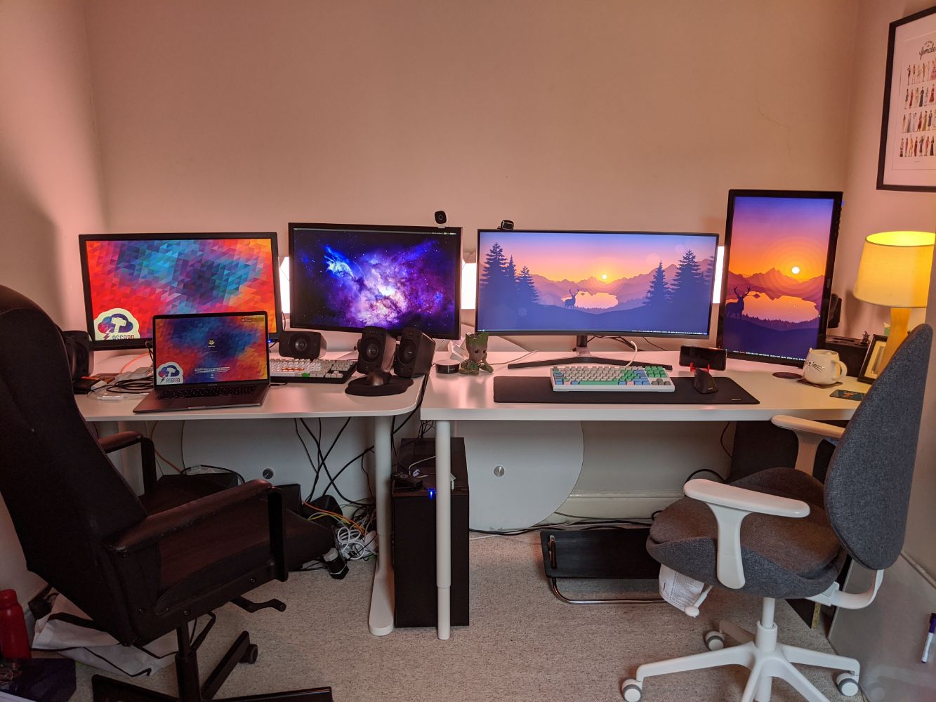 Jamie's desk on the left with two 28" monitors, one connected to his work Macbook Pro, and one to his desktop. Anna's desk on the right with an ultrawide and a portrait 27"connected to her desktop, each with a great mechanical keyboard