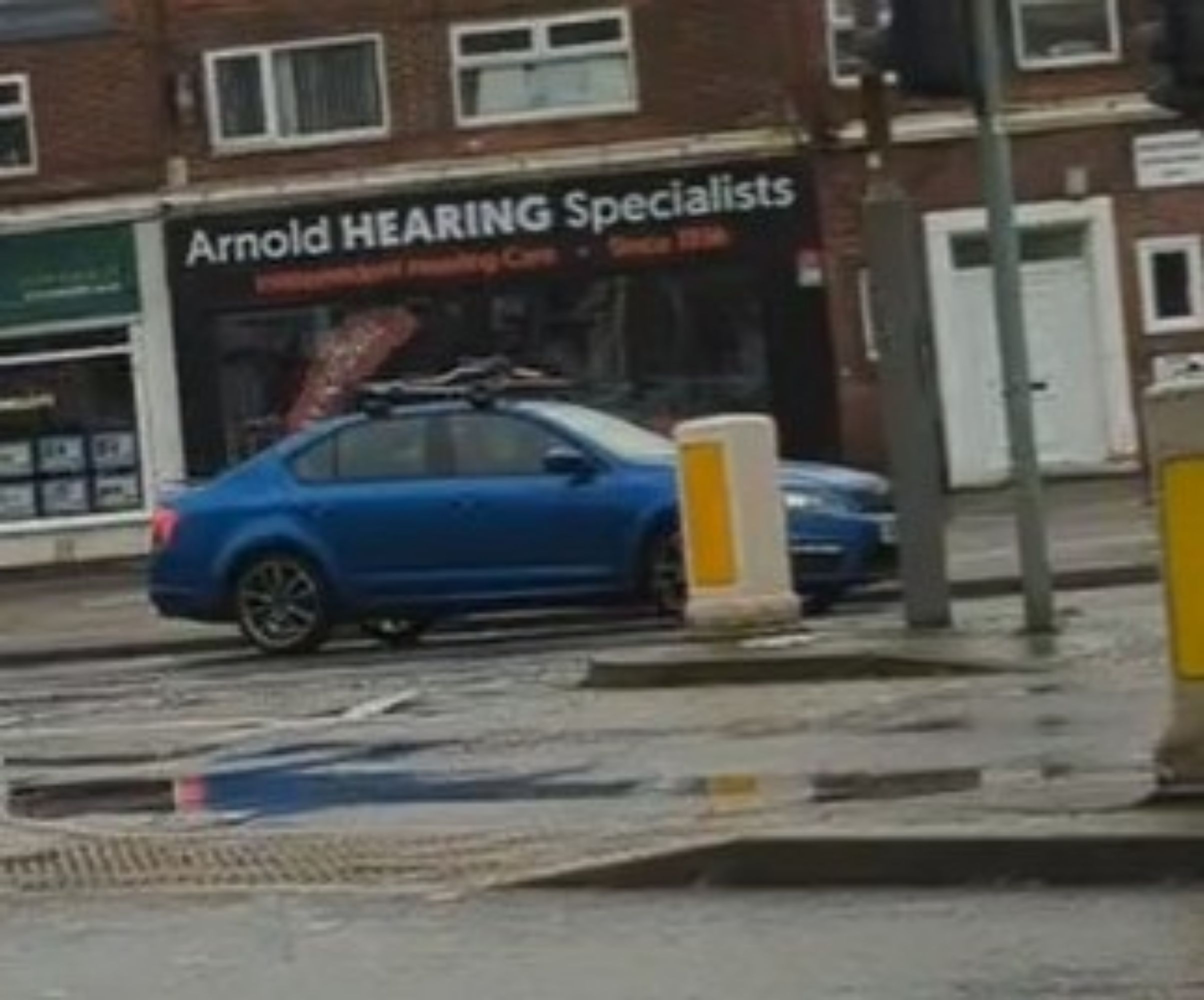 A photo of the Arnold Hearing Specialists shop front, but "hearing" is in all capitals, as if it's being shouted. And yes, this is a little ableist 😥 