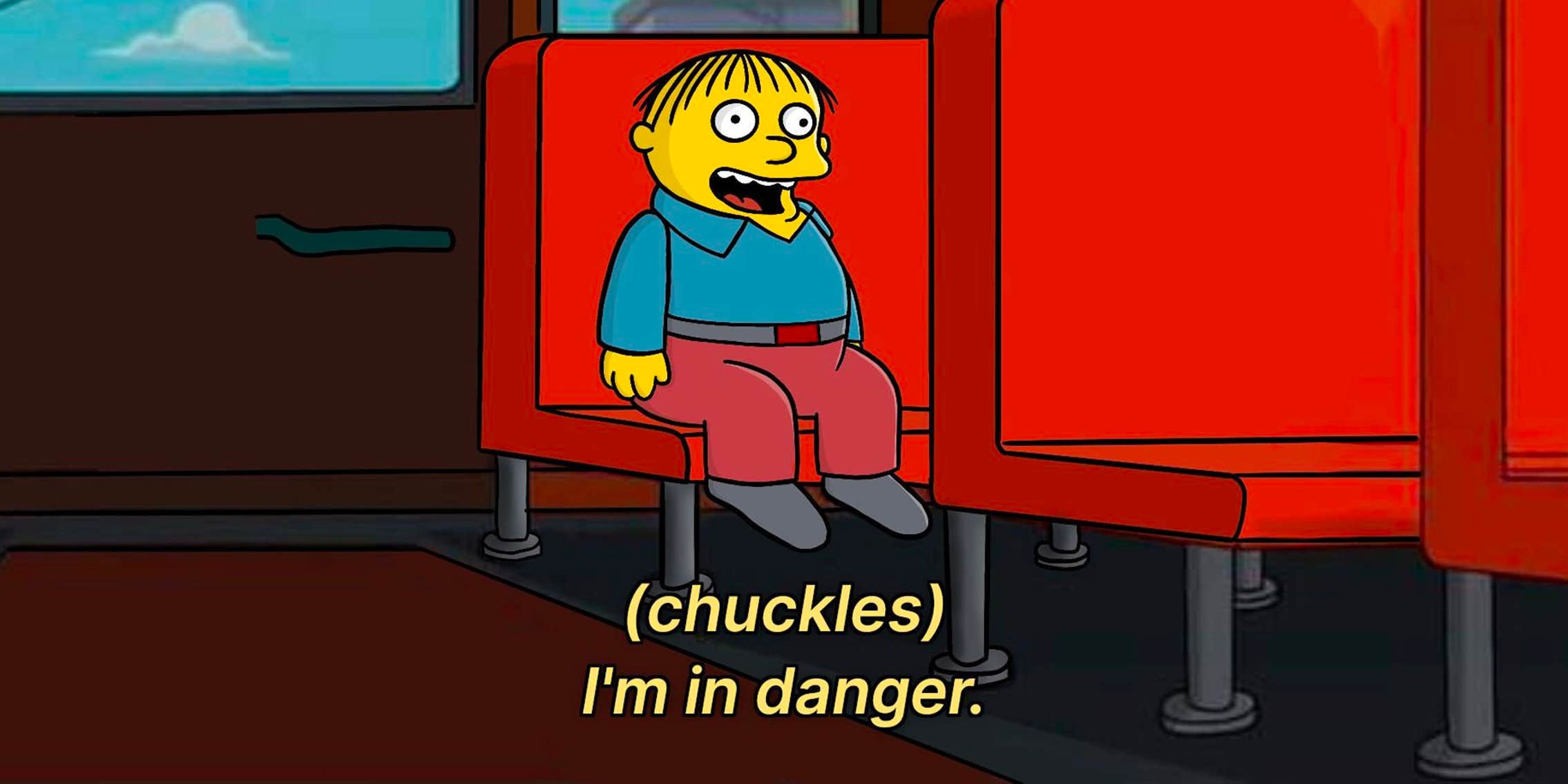 Ralph Wiggum from The Simpsons - in a crossover episode from Family Guy - where Ralph is at the back of the school bus while Peter Griffin and Homer Simpson are fighting (offscreen from this screenshot), and chuckles and says "I'm in danger"
