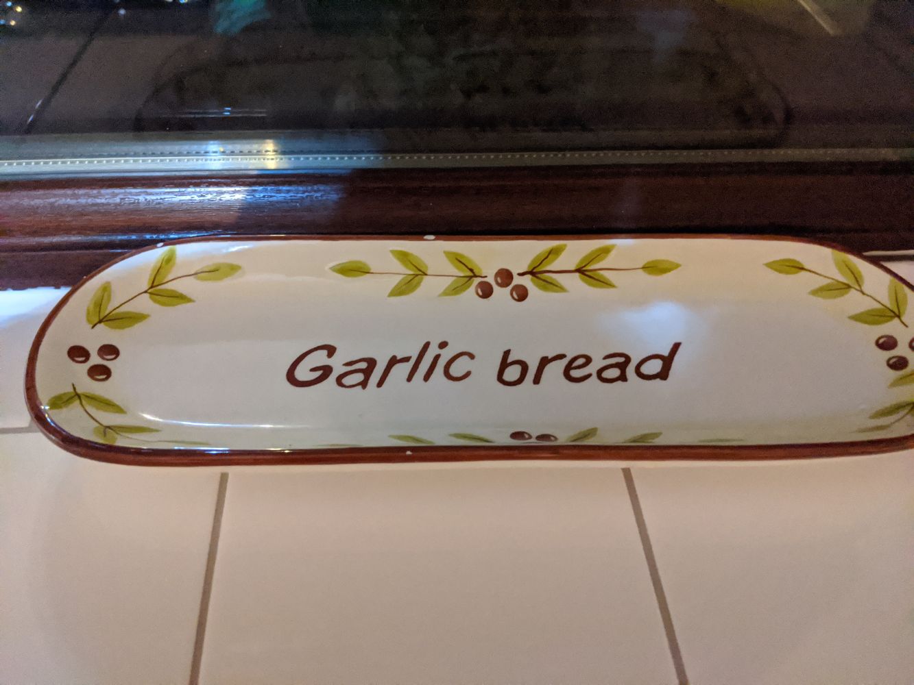 Serving tray with "garlic bread" written on it, referencing the 2016 meme